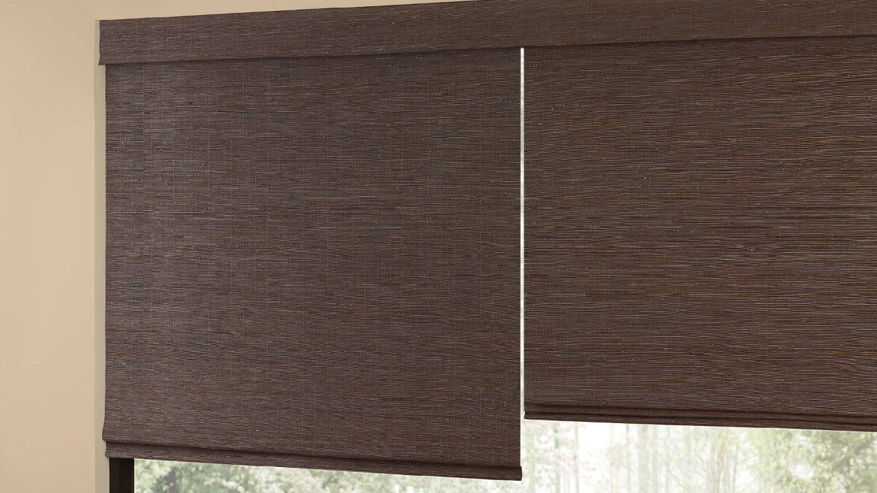 Dark-colored Hunter Douglas Provenance® Woven Wood Shades hanging in front of a window near Arlington, Texas (TX)